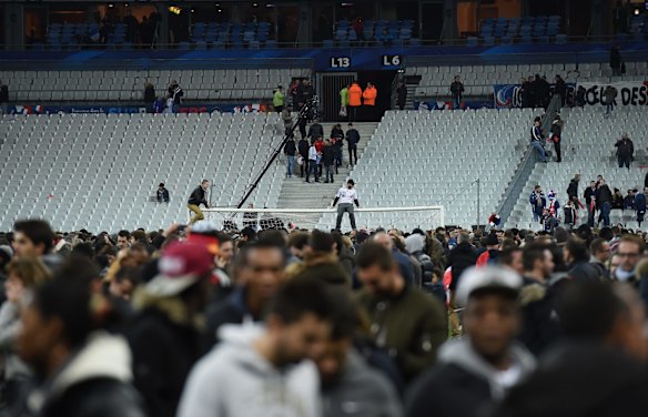 Spectators gather on the pitch of the Stade de France stadium following the International Friendly match between France and Germany at the Stade de France.