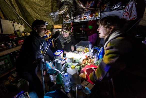 Protestors preparing food in a kitchen tent.