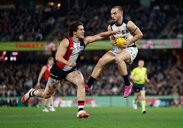 My ball: Blue Francis Evans marks ahead of Liam Stocker.