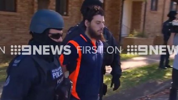 Mehmet Biber being arrested this morning in Birrong on terrorism and foreign incursion charges.