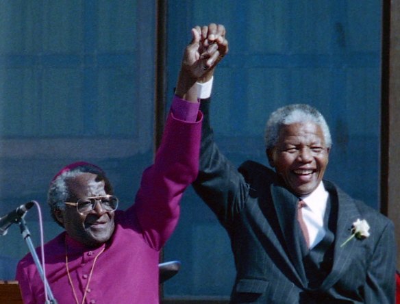 Former South African president Nelson Mandela, right, holding hands with former Bishop Desmond Tutu in 1994 in Cape Town South Africa. 