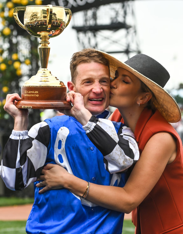To the winner, the spoils: Mark Zahra is congratulated by his wife Elyse Zahra.