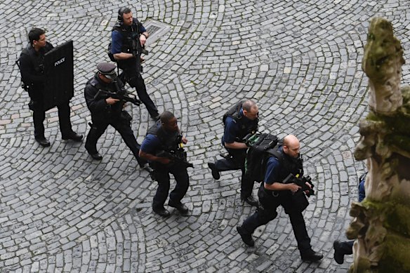 Armed police at the scene outside the Palace of Westminster, London.