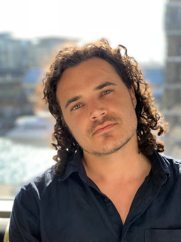 Sydney Morning Herald photographer Dominic Lorrimer poses for a back lit portrait. Photo was taken on portrait mode.

