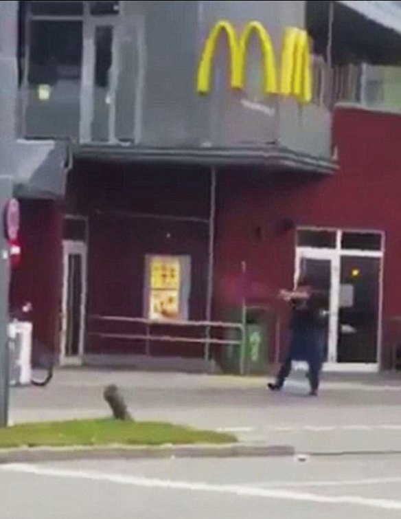 Terrified shoppers were seen running for their lives as the shooter, dressed in black, fires shots.