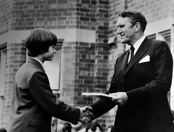 Former Prime Minister Malcolm Fraser presents a prize for consistent effort to T.J. Kimpton at Canberra Grammar school. (5/12/78)