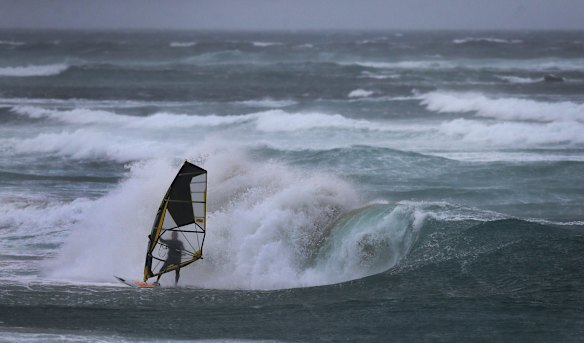 A wind surfer takes advantage of strong winds at Nobbys Beach, Newcastle.