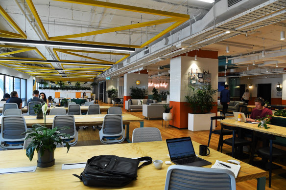 The general open plan area where people work in the JustCo shared workspace.