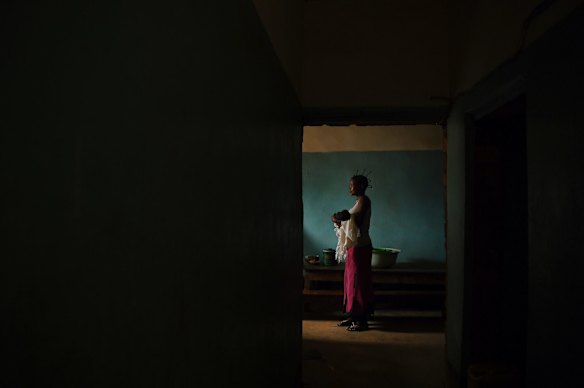 Mujinga Njindu, 18, holds her 6 day old baby Meta Fils in the maternity ward of the Moyo Health Centre in Tshimbulu village. 