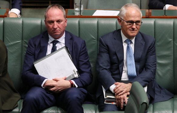 Deputy Prime Minister Barnaby Joyce and Prime Minister Malcolm Turnbull take a seat for a division during question time at Parliament House in Canberra on Wednesday 25 October 2017. 