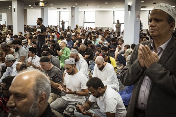 Mosque President Rifai A. Raheem (right) joins thousands in prayer at the Melbourne Grand Mosque in Tarneit.