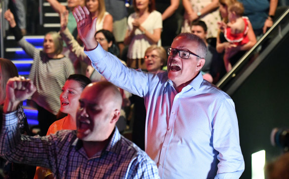 Scott Morrison sings during an Easter Sunday service at his Horizon Church at Sutherland.