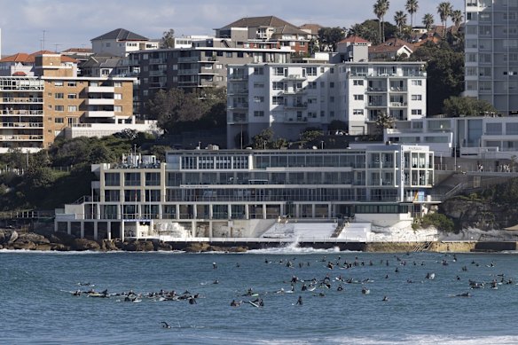 Surfers take to the waves to get some exercise during lockdown on Saturday, July 3.
