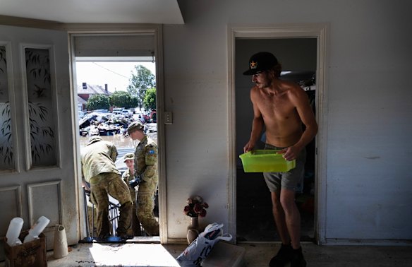 Members of the ADF join up with community volunteers to clear the house of elderly couple, Gail and Bill Ferrier, in Woodburn, in the Northern Rivers region of NSW.