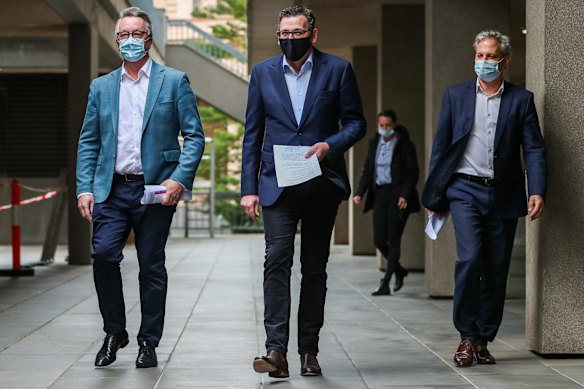 Victorian Health Minster Martin Foley (left),  Premier of Victoria Daniel Andrews (centre) and Victorian Chief Health Officer Brett Sutton (right) arrive for a Press Conference on September 19, 2021 in Melbourne, Australia. The Victorian Government has unveiled it's road map to ease restrictions once vaccinations targets are reached.