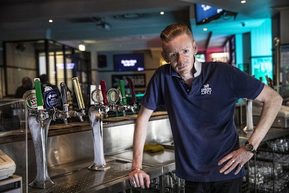 Not all venues saw celebrations as the manager of The Courthouse Hotel, Stewart John Cairns is pictured in a mostly empty bar on Oxford Street in Darlinghurst.