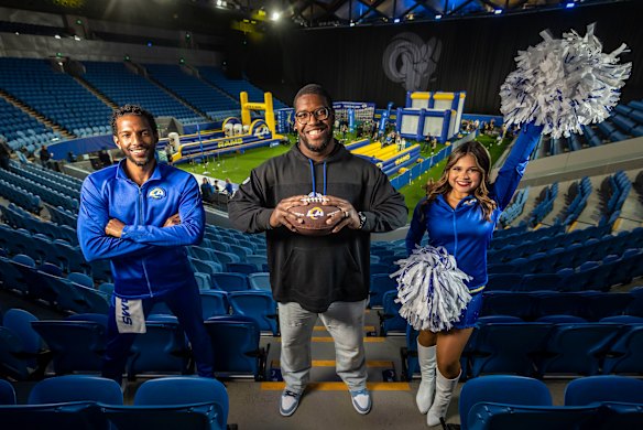 LA Rams defensive end Kobie Turner (centre), pictured with cheerleaders, at Margaret Court Arena on Sunday.