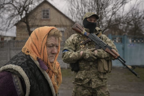 A woman waits for distribution of food in the village of Motyzhyn.