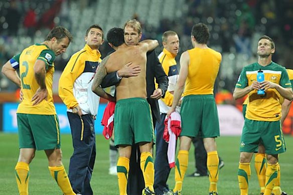 Tim Cahill hugs coach Pim Verbeek after the match.