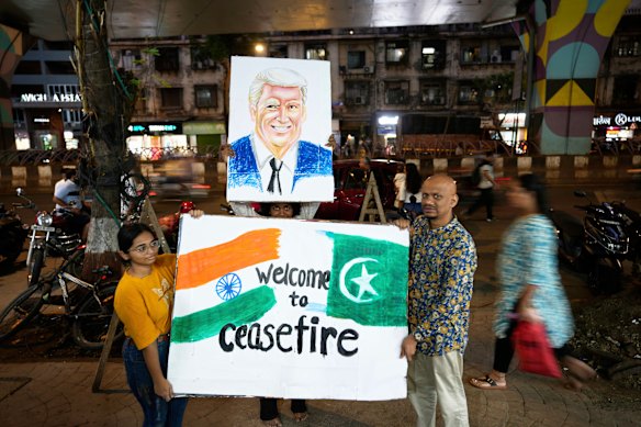 Students of an art school and their teacher carry a hand-drawn portrait of the US President Donald Trump as they celebrate the ceasefire between India and Pakistan.