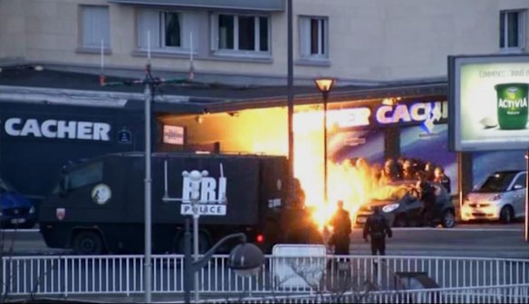 In this image taken from a video provided by PFMTV, police officers storm a kosher grocery to end a hostage situation in Paris. 