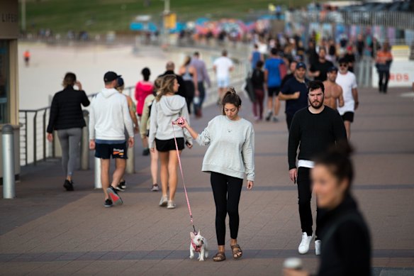 People walk on the promenade at Bondi beach.