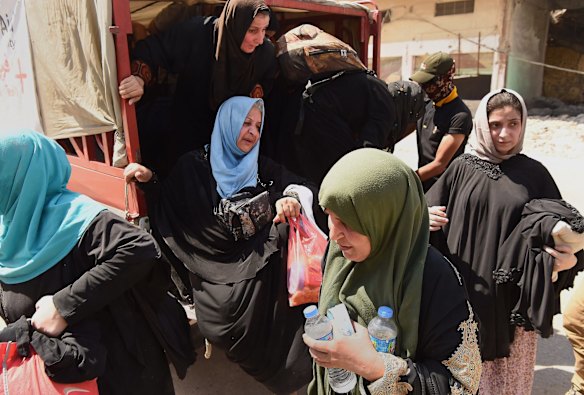 Families arrive at a screening point in West Mosul.