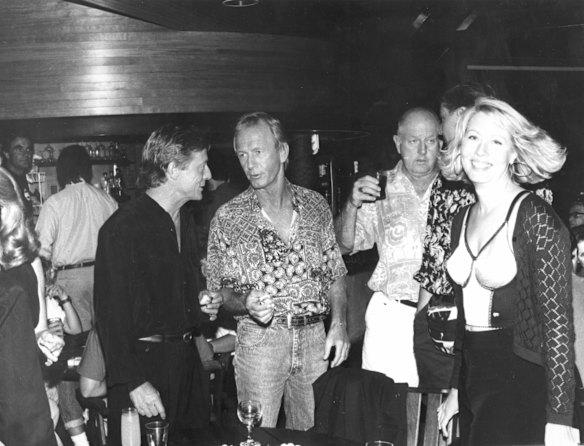 John Cornell, Paul Hogan and Linda Kozlowski mix with Byron Bay locals at the opening of Cornell's  Seaside Cafe. 6th December 1991.