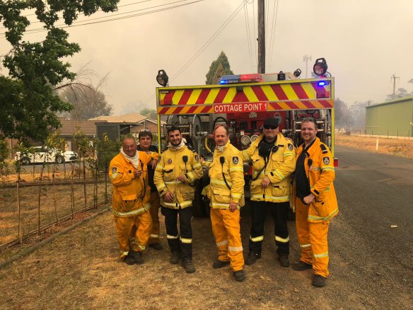 Jon Russell, (second from left, in blue shirt), a captain of the Cottage Point RFS brigade, says at least one member of his crew could be ineligible for the National Emergency Medal despite active and dangerous service during the 2019-20 bushfire season. 