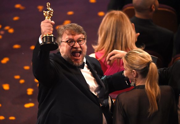 Guillermo del Toro, winner of the award for best director for <i>The Shape of Water</i> celebrates in the audience.