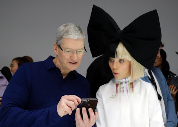 Apple CEO Tim Cook shows an iPhone 7 to Maddie Ziegler, who performed at the launch event.