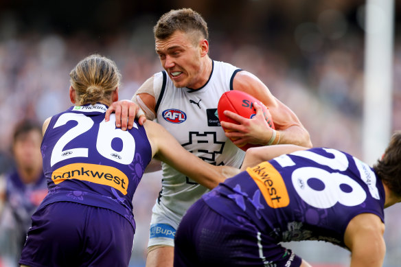 Leading the way: Patrick Cripps fends off two tacklers during the Blues’ win over the Dockers on Sunday.