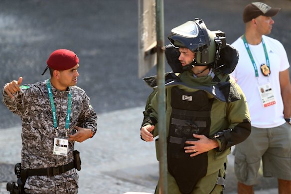 Members of the Brazillian bomb squad carry out a controlled explosion of a bag near the finish line of the Men's Cycling Road Race.