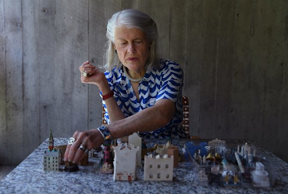 Penelope Seidler looks at small souvenir models at her home in Killara.