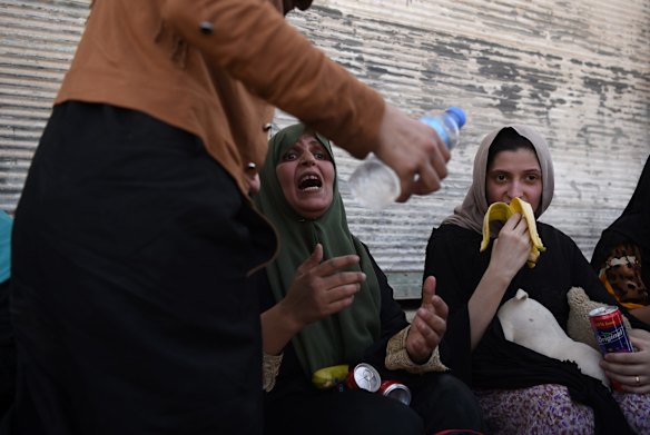 Emotional scenes as families arrive safely at a screening point after being rescued by Iraqi forces.