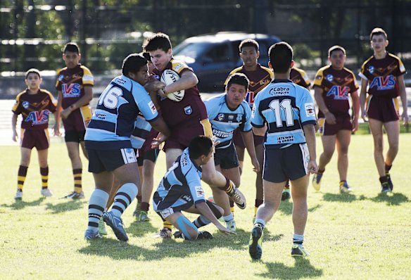 The game gets underway with a strong hit-up by one of the Guildford Owl forwards and is tackled by the Cabramatta Leagues junior team.