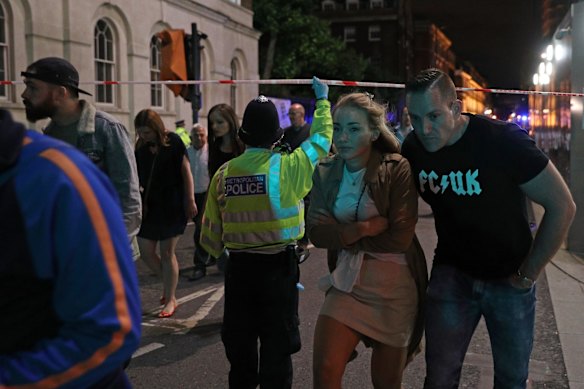Police officers clear the area near Borough market at London Bridge.