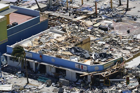 Commercial business are seen in the wake of Hurricane Ian, Thursday, Sept. 29, 2022, in Fort Myers Beach, Fla. (AP Photo/Wilfredo Lee)
