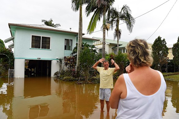 Tracey (right) and Laurie Batshaw (left) infront of their house in flooded Bright street in Lismore. 