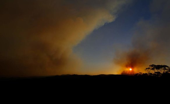 Plumes of smoke from rise from State Mine Fire and Mt York fire as the sun sets along the Bells Line of Road in the Blue Mountains.