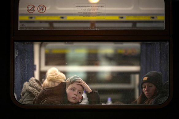 A boy looks out of the window as he arrives at Zahony train station as the influx of refugees from Ukraine continues in Zahony, Hungary.  
