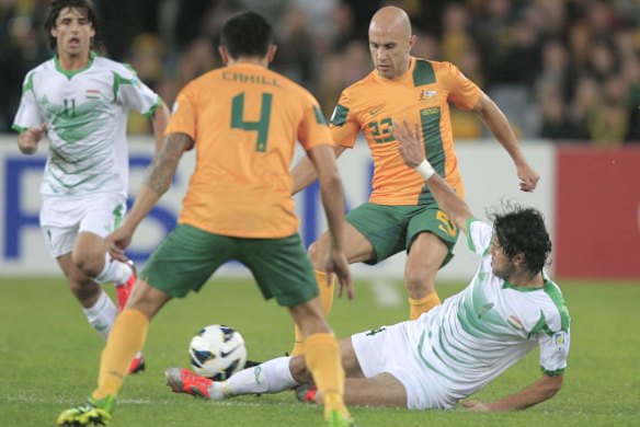 Mark Bresciano competes for the ball.