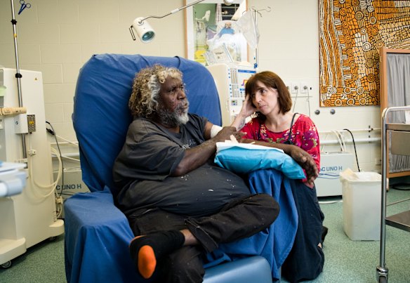 Bobby West Tjupurrula with CEO Sarah Brown, has dialysis treatment at the Purple House in Alice Springs.