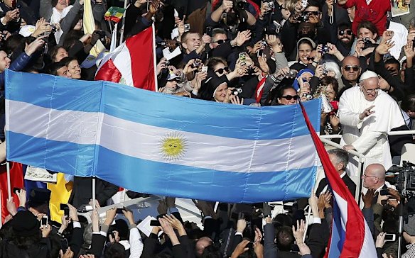 Pope Francis passes an Argentine flag as he arrives in Saint Peter's Square for his inaugural mass.