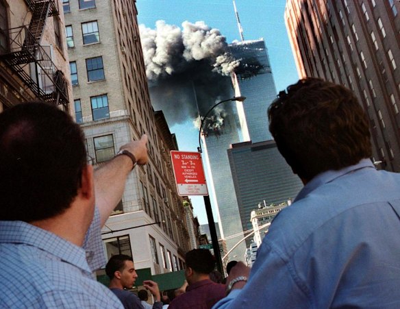 Pedestrians react to the collapse of New York's World Trade Center September 11, 2001. Two commercial airplanes crashed into the World Trade Center earlier.
