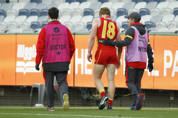 A doctor assists Gold Coast young gun Matthew Rowell.
