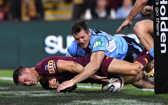 Brett Morris of the NSW Blues tackles Queensland's Cooper Cronk over the tryline during State of Origin Game 3. 