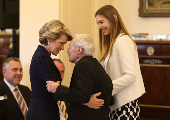 Julie Bishop welcomes Tony Abbott's father Dick at Government House in Canberra.