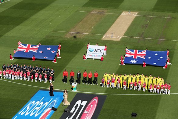 The teams line up for the national anthems before the start of the World Cup final at the MCG on Sunday.