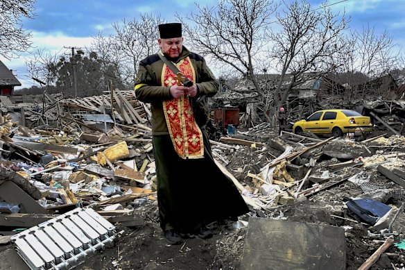 Mykola Medynsky, a Ukrainian army chaplain, arrived on Saturday to comfort Ihor Mozhayev and his family. Six people, including Mozhayev's 12-year-old disabled daughter, died in a suspected Russian airstrike.